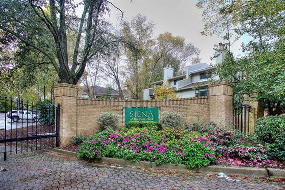 Front view of a building behind a brick wall with a sign reading 'Siena at Renaissance Park.'