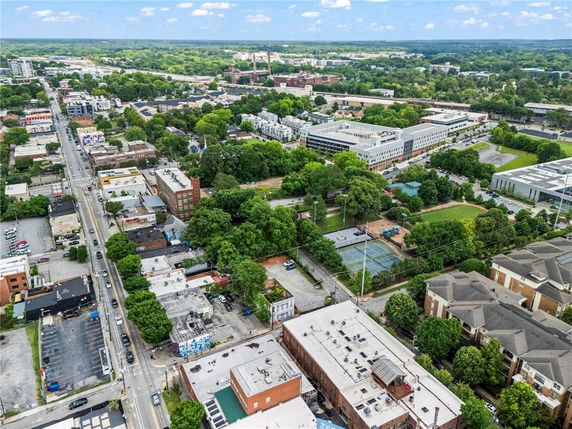 Aerial panoramic view of a city area with buildings, roads, and greenery.