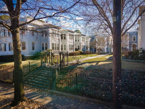 Front view of a multi-story residential building with steps leading to the entrance.