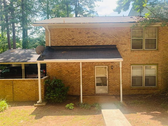 Front view of a two-story brick house with a covered entrance.