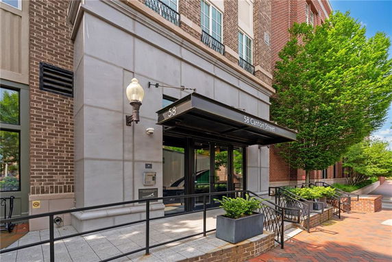 Front view of a building entrance with a canopy and glass doors.