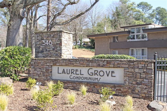 Front view of a condominium building with stone signage.
