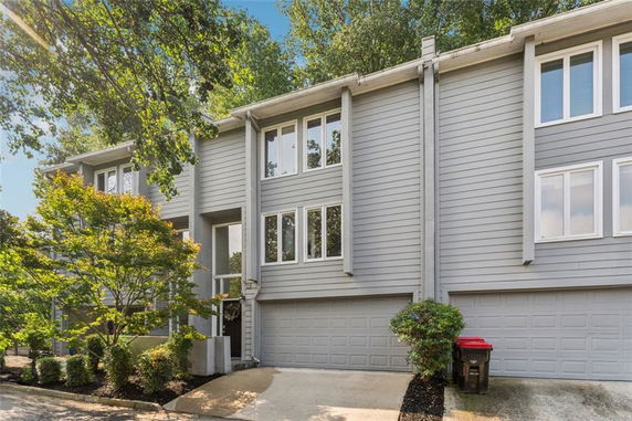 Front view of a multi-story house with an attached double garage.