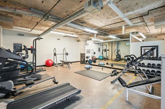 Indoor gym area with various fitness equipment.