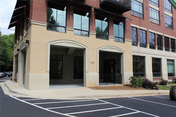 Front view of a building with large windows and brick facade.