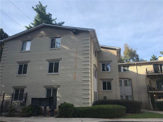 Front view of a multi-story brick apartment building.