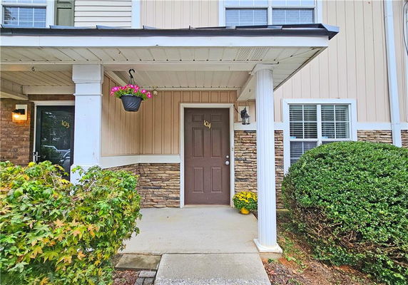 Front view of a house entrance with a covered porch.