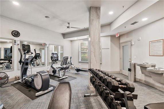 Indoor gym area with exercise equipment and weights.