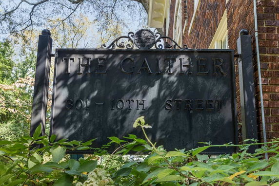 Front view of a brick building with a sign reading 'The Gaither 301 - 10th Street'.
