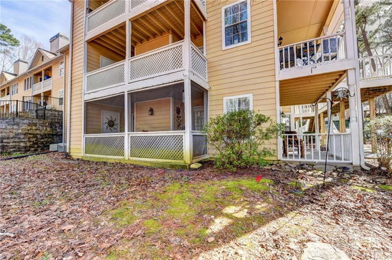 Exterior view of a multi-story residential building with balconies and screened porch areas.
