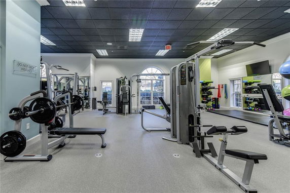 Indoor gym area with workout equipment and exercise machines.