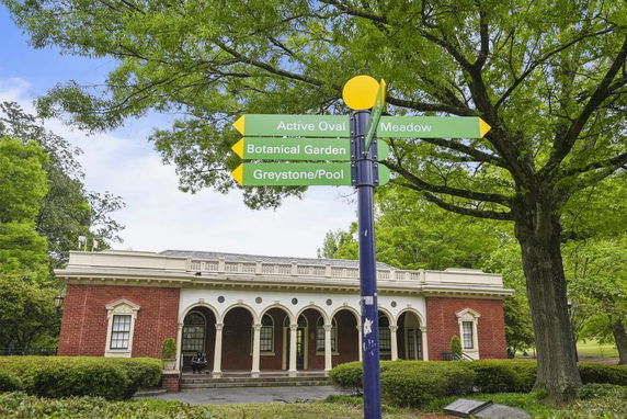 Front view of a building with brick walls and arched entrances.