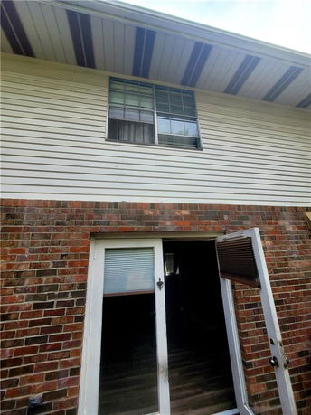 Front view of a two-story house with brick and siding exterior.