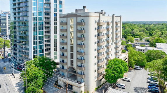 Elevated view of a multi-story residential building with balconies.