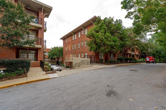 Front view of a multi-story brick apartment building.