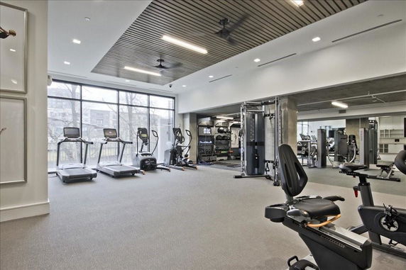 Interior view of a gym area with exercise equipment, including treadmills and bikes.