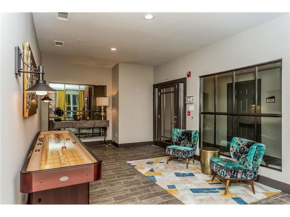 Indoor recreation area with a shuffleboard table and seating.
