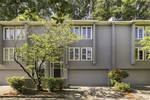 Front view of a two-story house with multiple windows and a double garage.