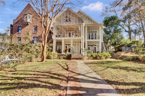 Front view of a two-story house with multiple balconies.