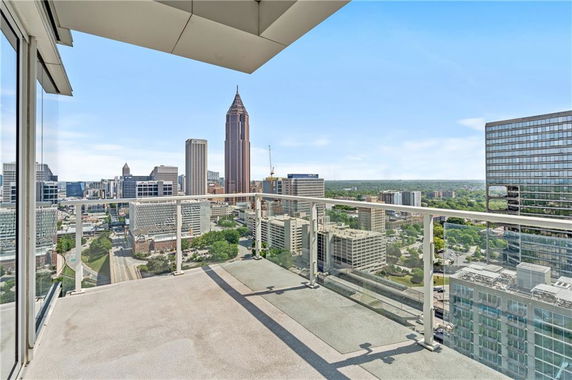 Balcony view overlooking a cityscape with multiple high-rise buildings.