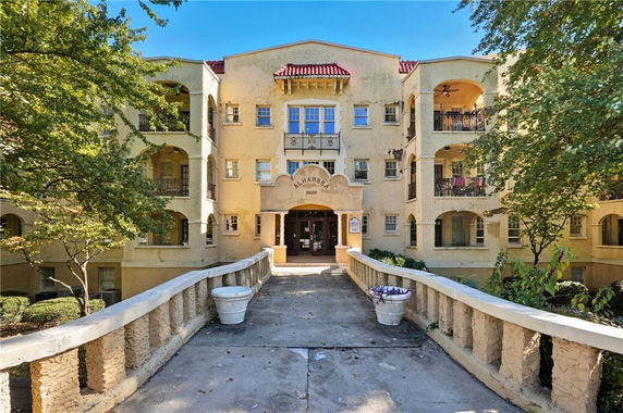 Front view of a multi-story building with distinct balconies.