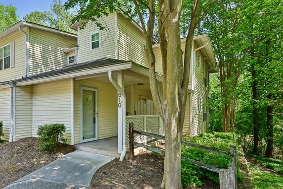 Front view of a two-story house with a covered entrance and siding exterior.