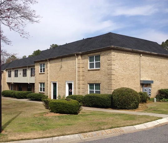 Front view of a two-story brick apartment building.