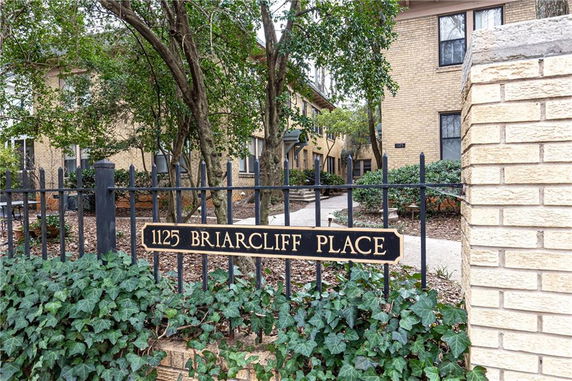Front view of a brick building with a gated entrance marked as 1125 Briarcliff Place.