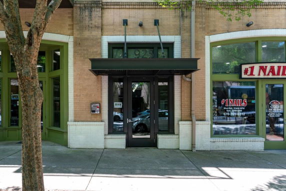 Front view of a commercial building with glass doors and windows.