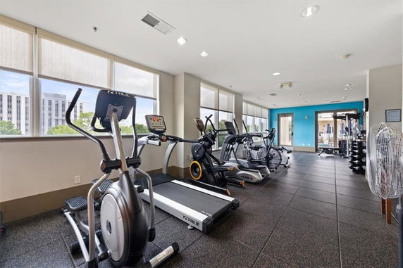 Indoor gym area with exercise equipment including treadmills and elliptical machines.