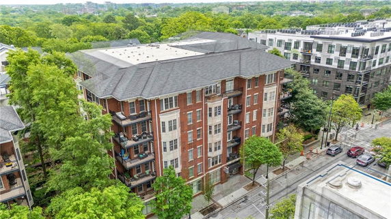 Front view of a multi-story brick residential building in an urban area.