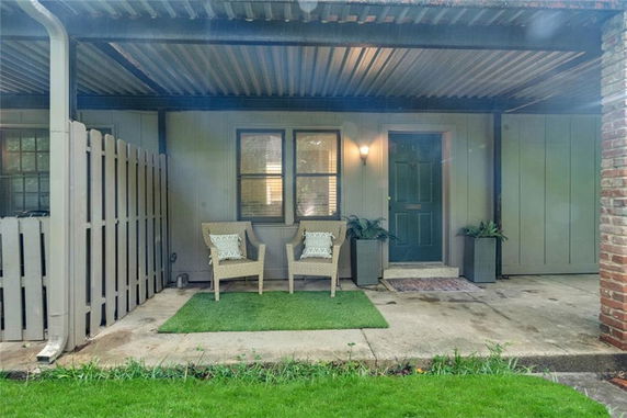 Front view of a house with a covered porch and seating area.