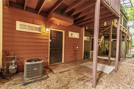 Front view of a building with multiple levels and a visible air conditioning unit.