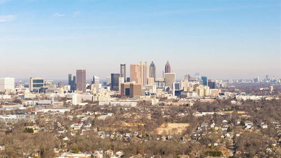 Wide-angle view of a city skyline with numerous buildings and skyscrapers.