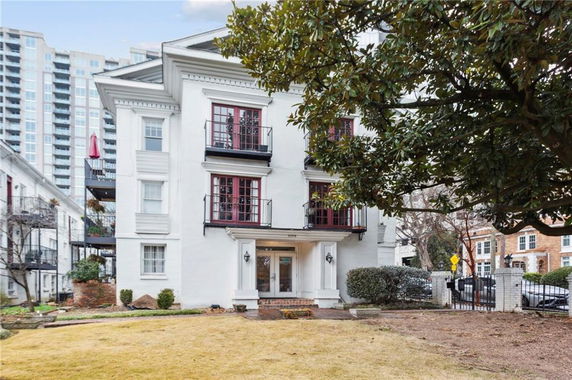 Front view of a multi-story building with balconies.