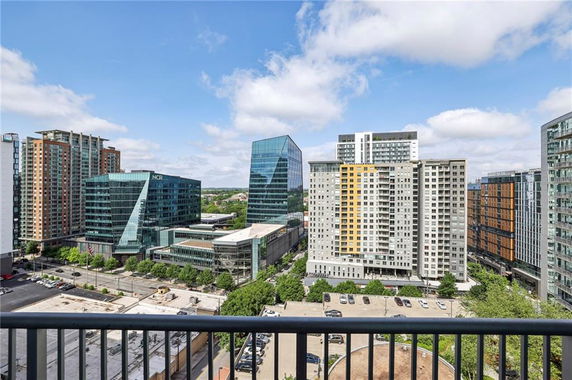 Panoramic view of city buildings from a balcony.