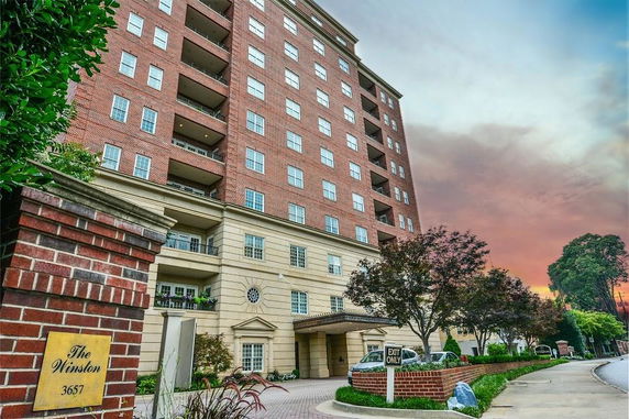 Front view of a multi-story residential building with balconies.