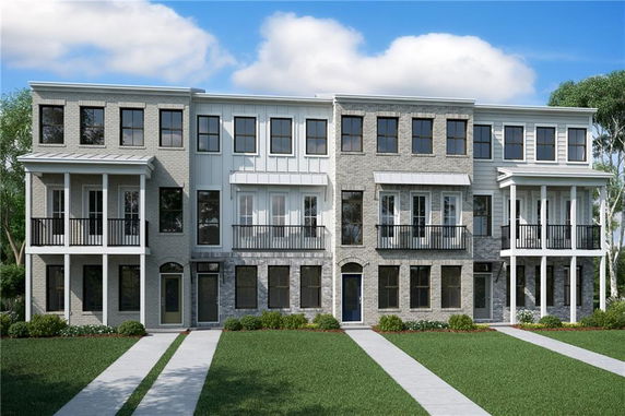 Front view of a three-story townhouse complex with multiple units.