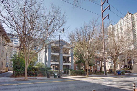 Front view of a multi-story residential building with balconies.