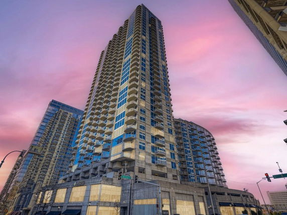 Front view of a high-rise building with multiple balconies and a modern design.