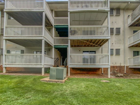 Front view of a multi-story building with multiple balconies.