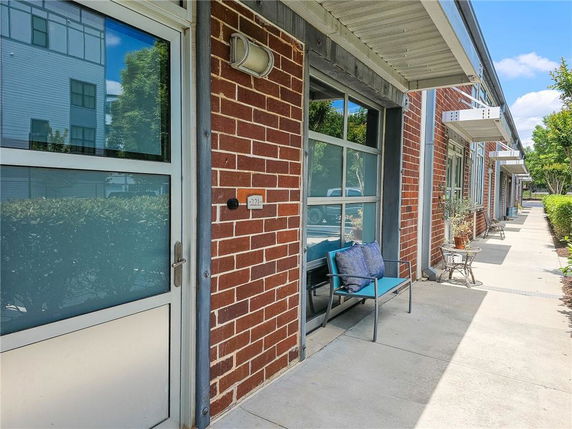 Front view of a building with brick walls and glass doors.