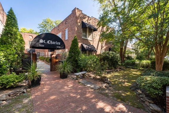 Front view of a brick building with an entrance canopy labeled 'St. Charles' and gated entry.