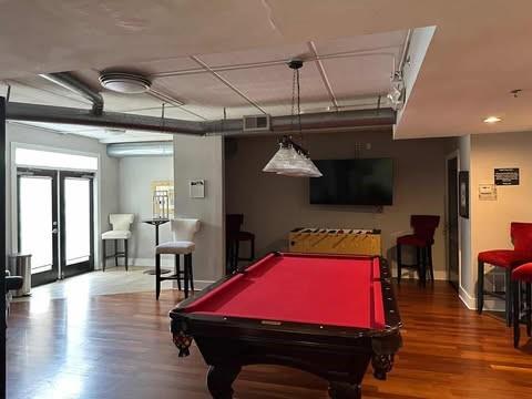 Indoor recreation area with billiards table and seating.