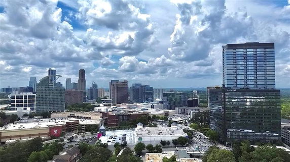 Panoramic view of a cityscape with multiple modern high-rise buildings.