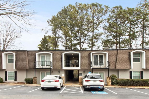 Front view of a two-story building with parking area.