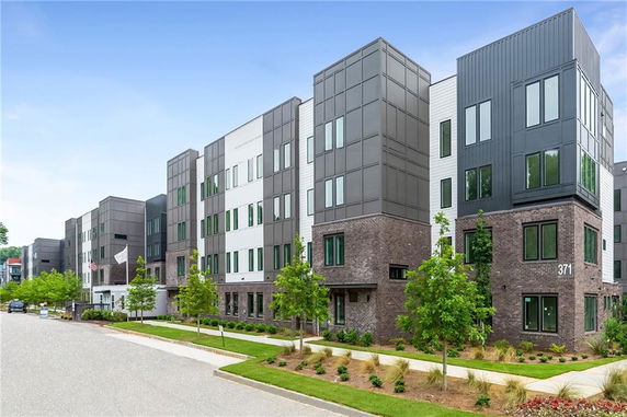 Front view of a multi-story apartment building with a modern design.