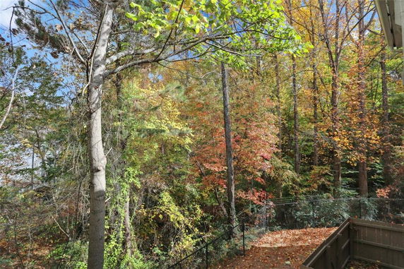 View of a forested area with autumn foliage seen from a building.