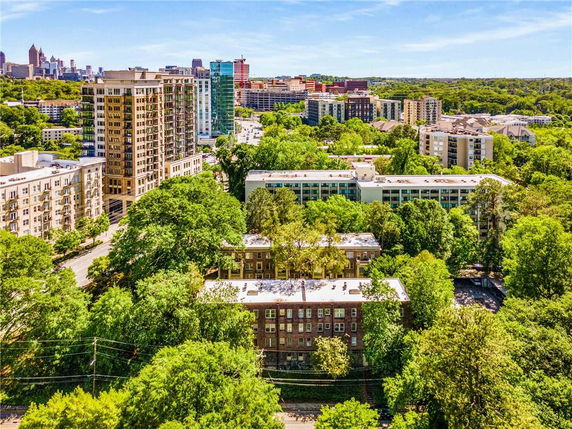 Wide-angle view of multiple residential buildings in an urban area surrounded by trees.