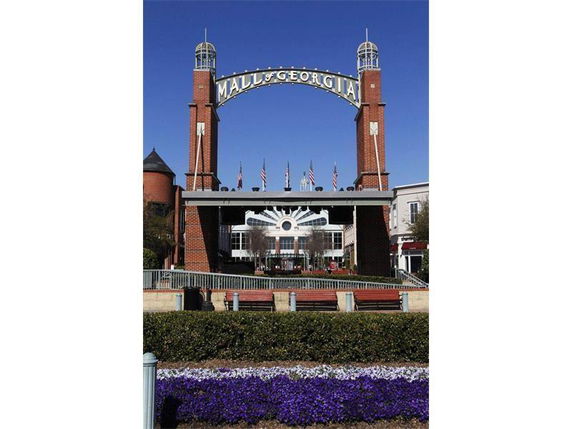 Front view of a large shopping center with brick towers and a sign reading 'Mall of Georgia.'